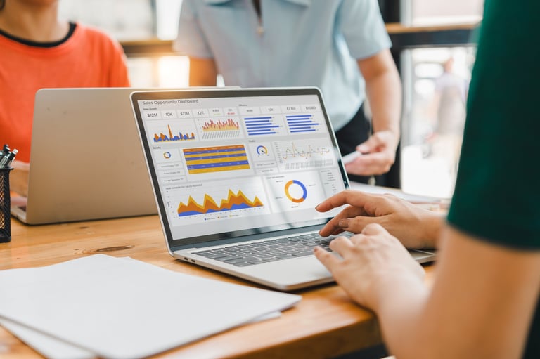 A person interacts with a digital sales dashboard displaying various performance metrics and analytics